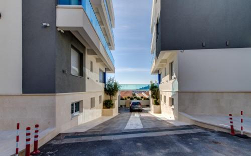 a car parked in a parking lot between two buildings at Villa Blue Panorama in Budva