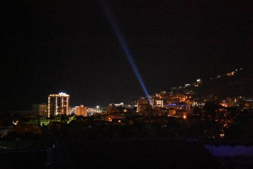 a view of a city at night with lights at Villa Blue Panorama in Budva