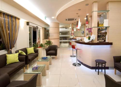 a lobby of a hospital with couches and a bar at Hotel Adigrat in Riccione