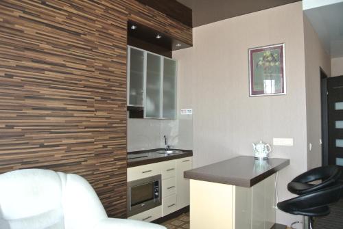 a kitchen with a counter and a sink in a room at Panoramic view apartment Poznyaky in Kyiv
