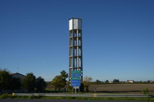 a pole with street signs in front of a building at L'incrocio - Bed&Breakfast in Imola