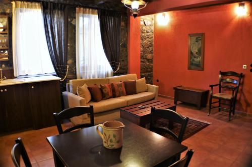 a living room with a couch and a table at Zeidoro in Palaios Agios Athanasios