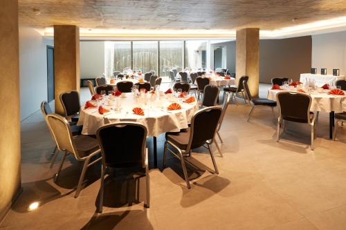 a conference room with tables and chairs in a building at Fosshotel Husavik in Húsavík