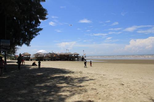 a group of people standing on a beach at Marose Gold Coast Morib in Morib