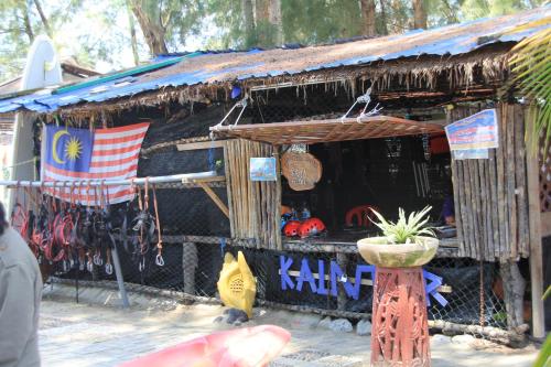 a store with an american flag in front of it at Marose Gold Coast Morib in Morib