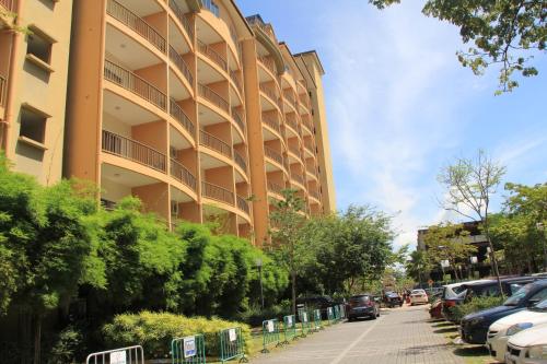 a tall building with cars parked in front of it at Marose Gold Coast Morib in Morib