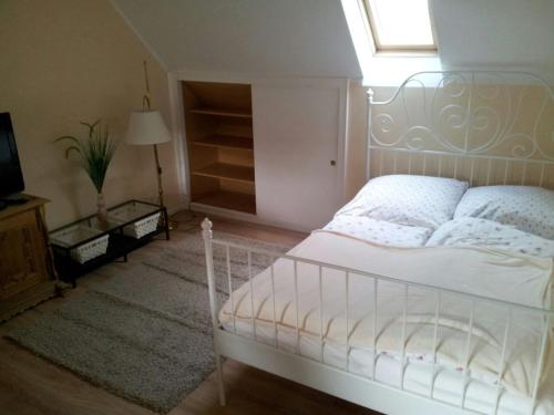 a bedroom with a white bed and a window at Nordsee-Lilie in Wilhelmshaven