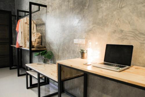 a laptop computer sitting on a wooden desk in a room at La moon in Ban Pa Tung (7)
