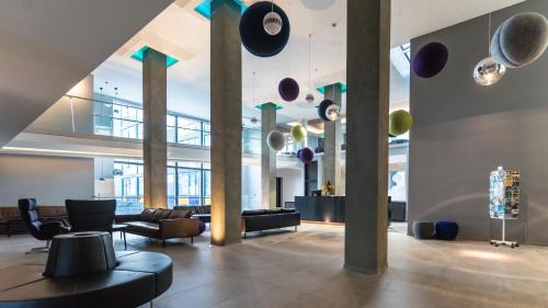 a lobby with couches and chairs in a building at Fosshotel Husavik in Húsavík