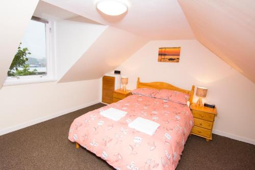 a bedroom with a bed and a window at Bayview Self-Catering, Lerwick in Lerwick