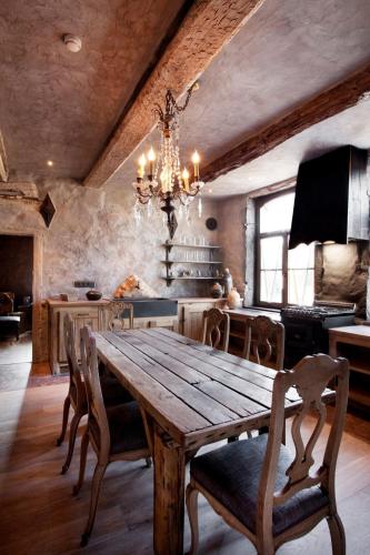 a dining room with a wooden table and a chandelier at Ne5t Hotel & Spa in Namur