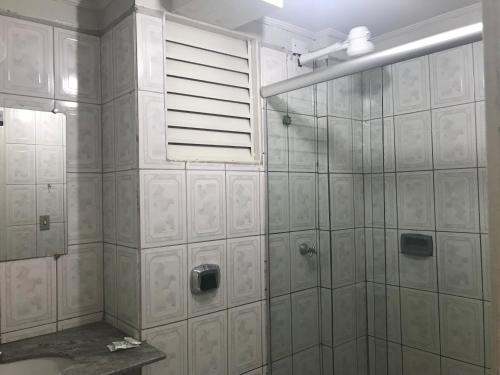 a bathroom with a shower and a window at Hotel Galli in Campo Grande