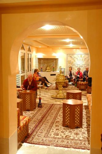 a group of people sitting at tables in a room at El Mouradi Tozeur in Tozeur