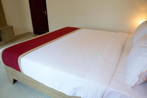 a large white bed in a room at Hotel Blue Bell in Bengaluru