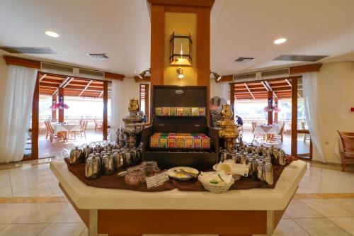 a room with a table with a bunch of soda cans at Aegean Melathron Thalasso Spa Hotel in Kallithea Halkidikis