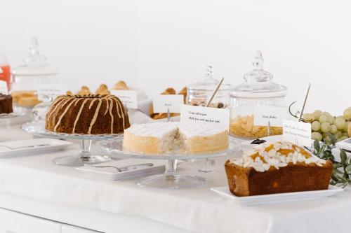 a display of cakes and other desserts on a table at Giovì Relais in Polignano a Mare