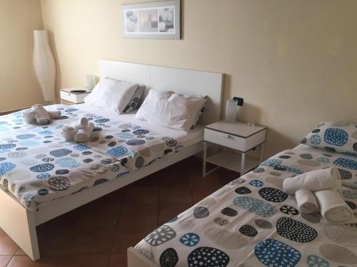 a bedroom with two beds with teddy bears on them at B&B Happiness in the Country in Brescello