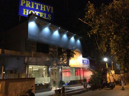 a building with lights on the side of it at night at Prithvi Hotels in Ahmedabad