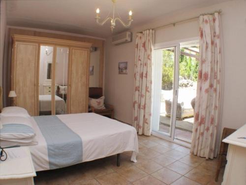 Postel nebo postele na pokoji v ubytování Villa Jacaranda