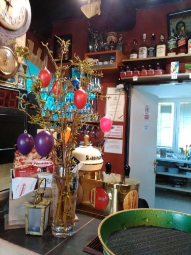 a table with a vase with balloons on it at Penzion Pomodoro in Vrbno pod Pradědem