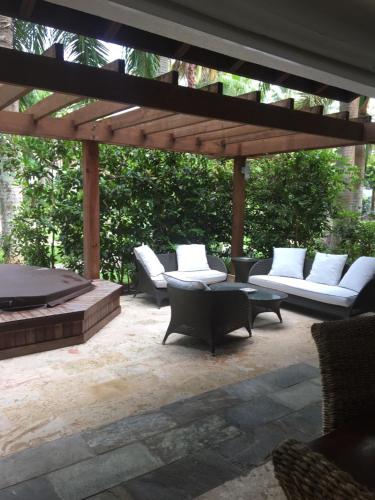 a patio with white couches and a fire pit at Apartment Balcones Del Atlantico in Las Terrenas