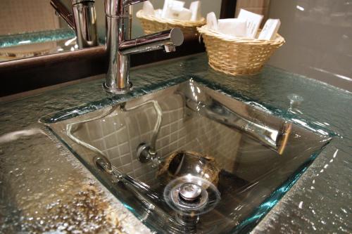 a sink with a faucet on top of a counter at Vitivola Pleta Peu del Riu Incles in Canillo