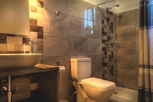a bathroom with a toilet and a sink at Villa Jasmin Studios in Gouvia
