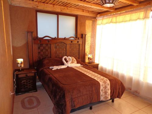ZIRAHUÉN CUIN Habitaciones Rústicasにあるベッド