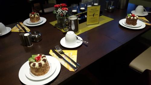 a table with three plates of food on it at Burghotel Stargard in Burg Stargard