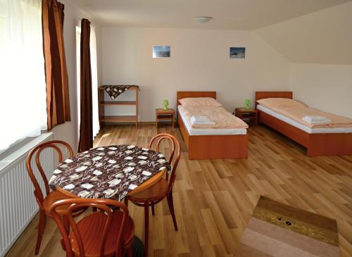 A bed or beds in a room at Apartmany Broma