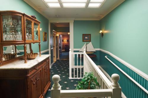 a hallway with a staircase with blue walls and a stair case at Hotel Mac in Richmond