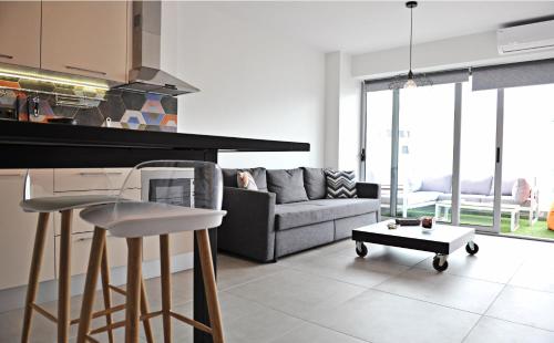 a kitchen and living room with a couch and a table at The Athenians Modern Apartments in Athens