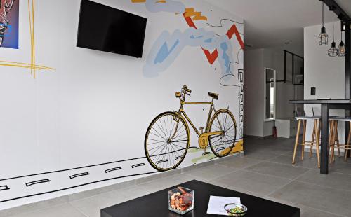 a bike on the wall in a living room at The Athenians Modern Apartments in Athens