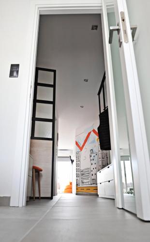 an open door in a room with a ladder at The Athenians Modern Apartments in Athens