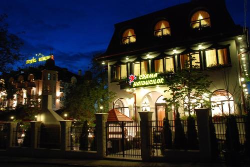 a building with a sign on the side of it at night at Crama Haiducilor in Cluj-Napoca