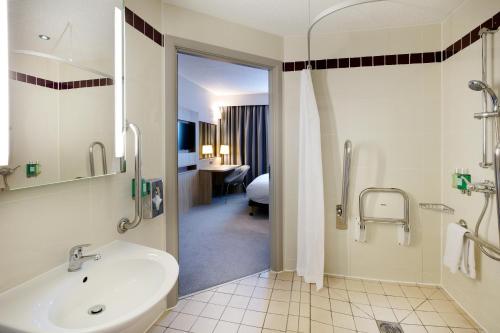a bathroom with a tub and a sink and a shower at Leonardo Hotel London Watford- Formerly Jurys Inn in Watford