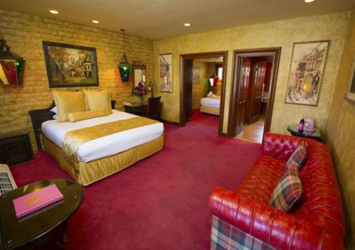 a hotel room with a bed and a couch at Madonna Inn in San Luis Obispo