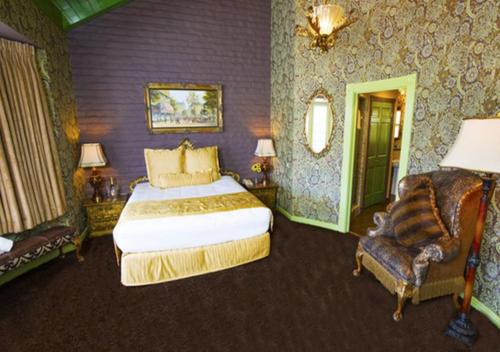 a bedroom with a king sized bed and a chair at Madonna Inn in San Luis Obispo