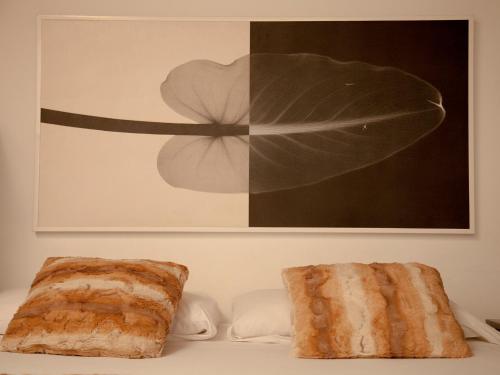 two pieces of bread sitting on a table under a picture at Flats Friends Tetuan in Valencia
