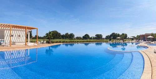 a large swimming pool with blue water at Radisson Blu Resort, Saidia Garden in Saidia 