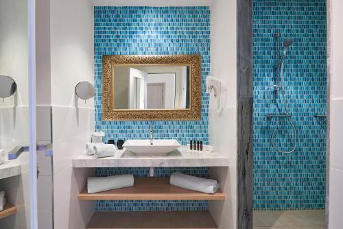 a bathroom with a sink and a shower at Radisson Blu Resort, Saidia Garden in Saidia 