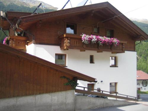 a building with flower boxes on the side of it at Haus Wildschütz in Sölden