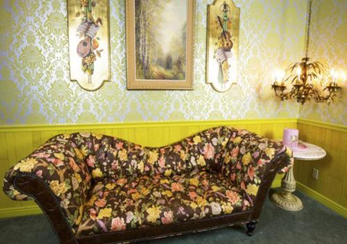 a living room with a couch in a room with wallpaper at Madonna Inn in San Luis Obispo