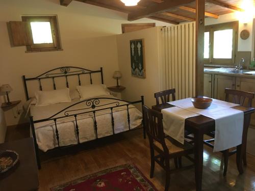 a bedroom with a bed and a table and a kitchen at The Nest in Orvieto