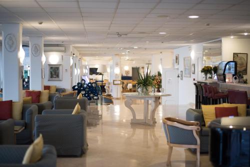 a lobby with chairs and tables in a store at Hotel Weber Ambassador in Capri