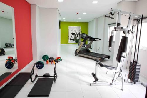 a gym with two treadmills and exercise bikes at Serras Hotel in Cuiabá