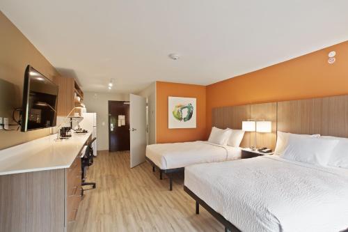 a hotel room with two beds and a kitchen at Extended Stay America Premier Suites - Providence - East Providence in East Providence