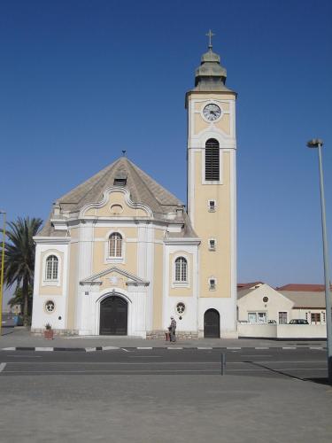 a large white church with a clock tower at Marietjie's Guesthouse in Swakopmund