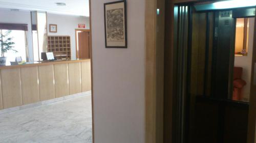 a hallway with a waiting room and a door at Hostal Juanito in Móstoles