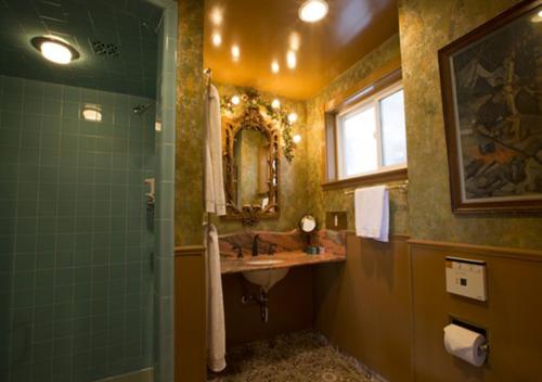 a bathroom with a sink and a shower with a mirror at Madonna Inn in San Luis Obispo